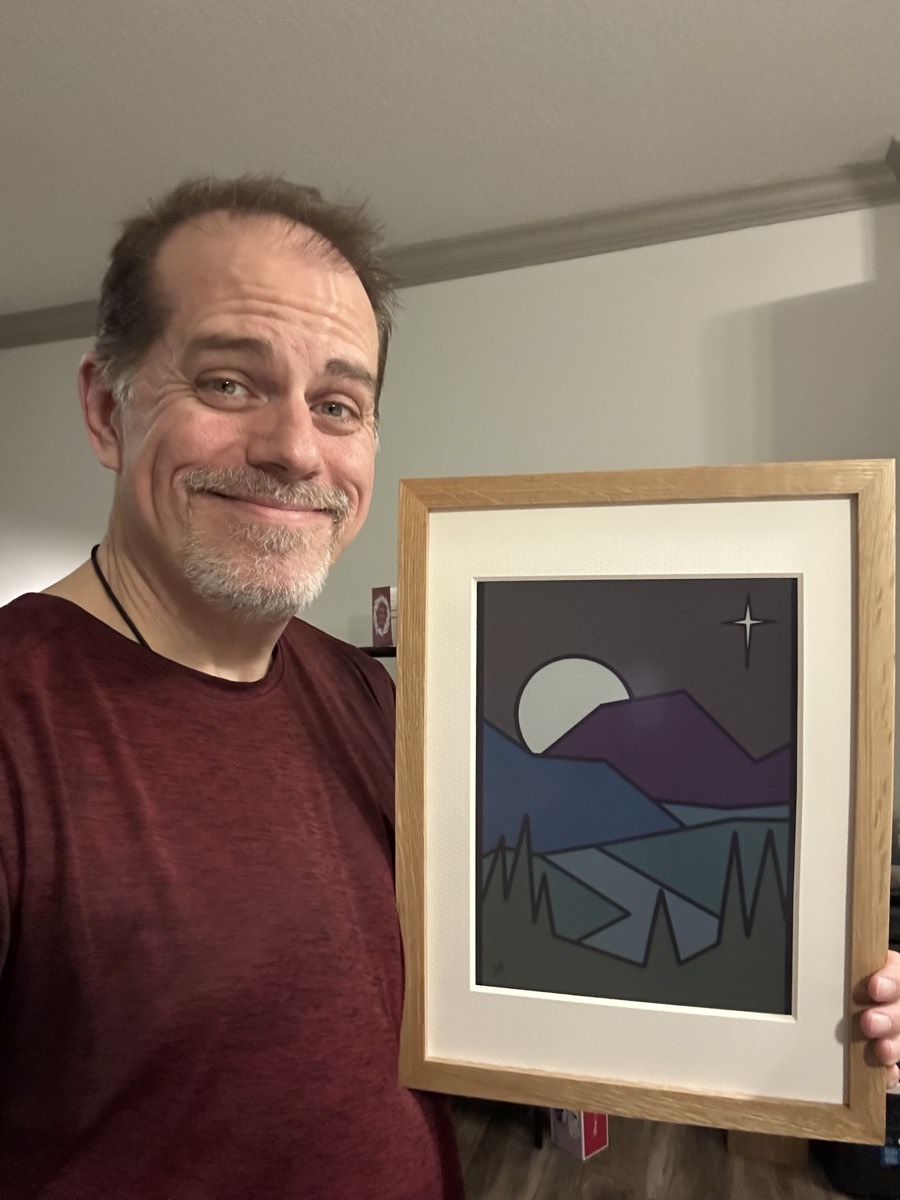 Me holding Creation & God's Nature on an e-ink frame