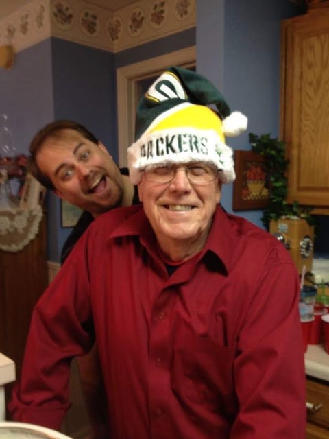 Grandpa in his Green Bay Packers hat and me photobombing in the background