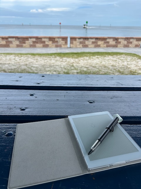 Supernote on a picnic table with the ocean