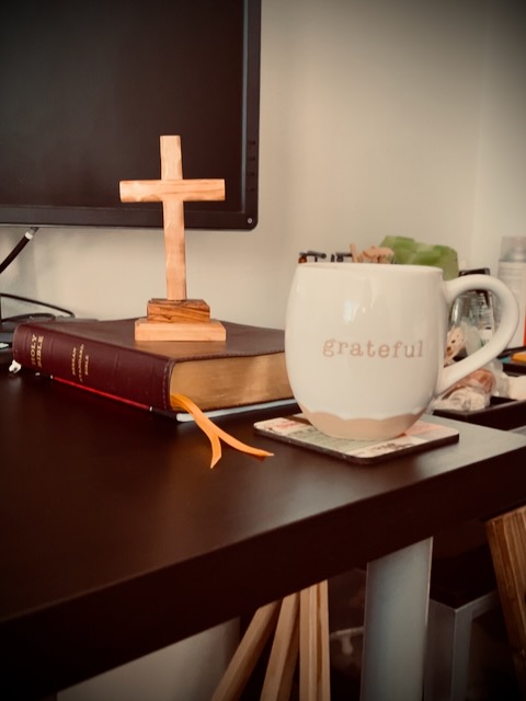 Cross, Bible, coffee mug with the word grateful on it