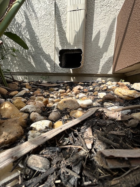 Gutter outlet with rocks