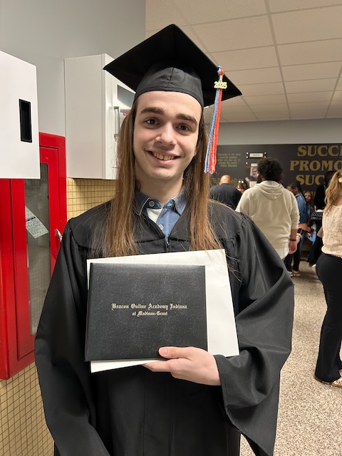 Malachi with his diploma folio