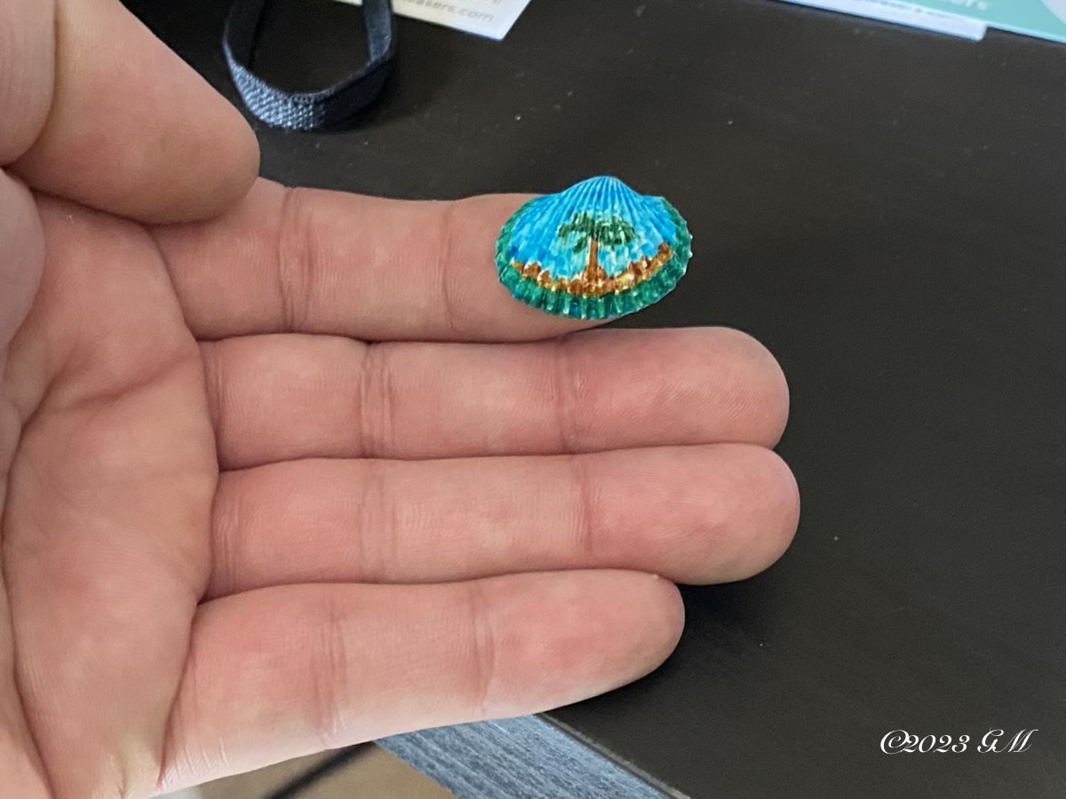 Zoomed out view of Beach on Shell painting showing how small it is compared to my hand