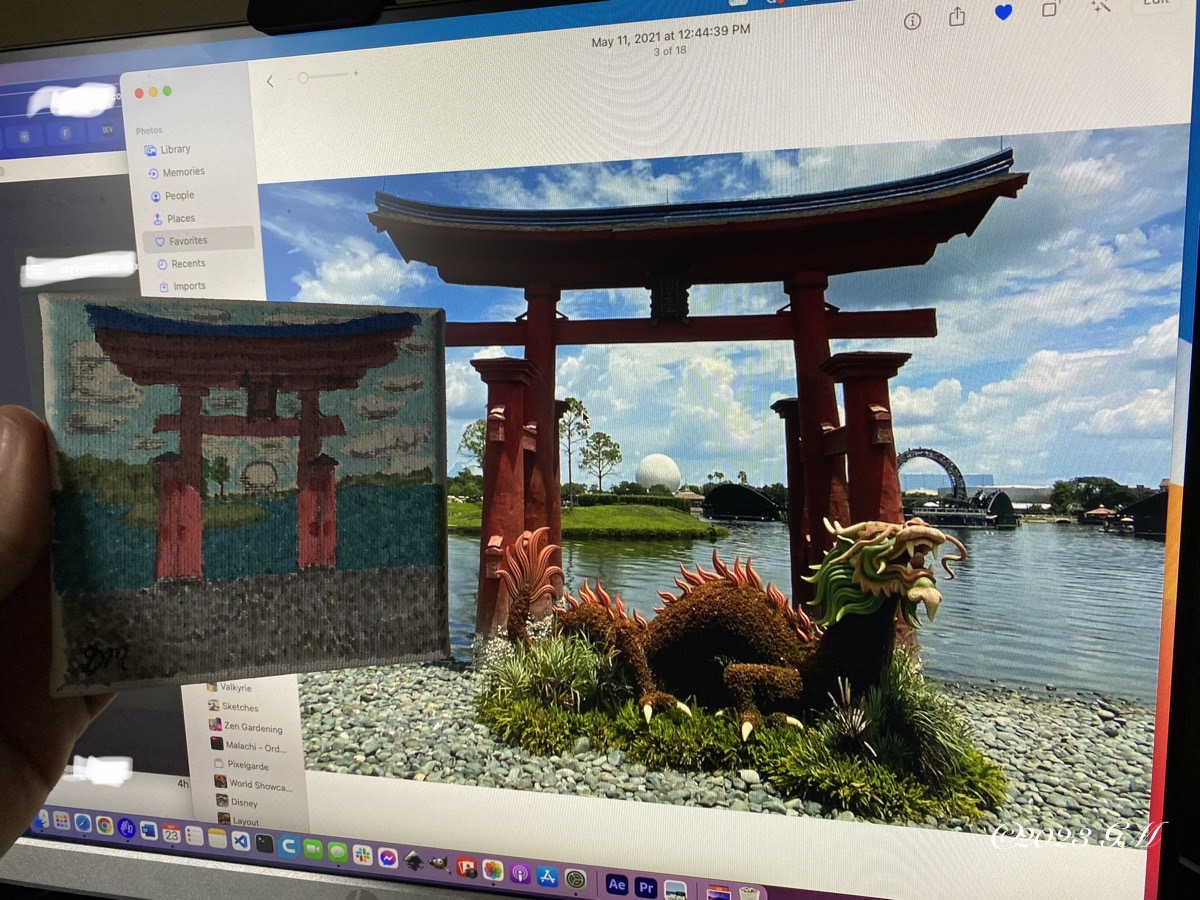 The Torii Gate painting being held up in front of the reference photo