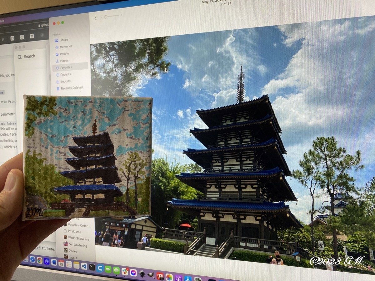 Japan Pavilion Pagoda painting being held up in front of a digital image of the pagoda in the Japan Pavilion at EPCOT