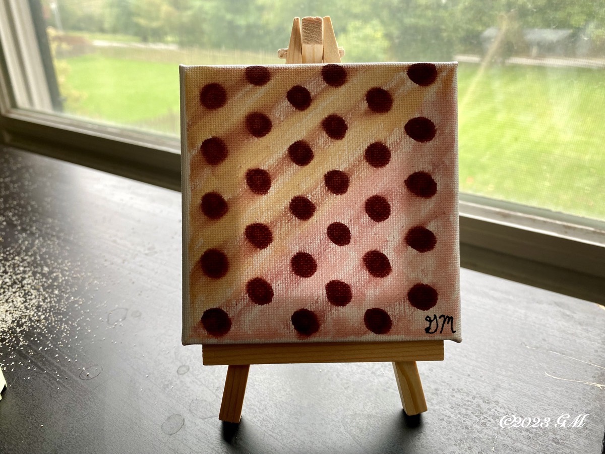 Poke Dots at Dusk painting on a mini easel being displayed on a desk in front of a window.