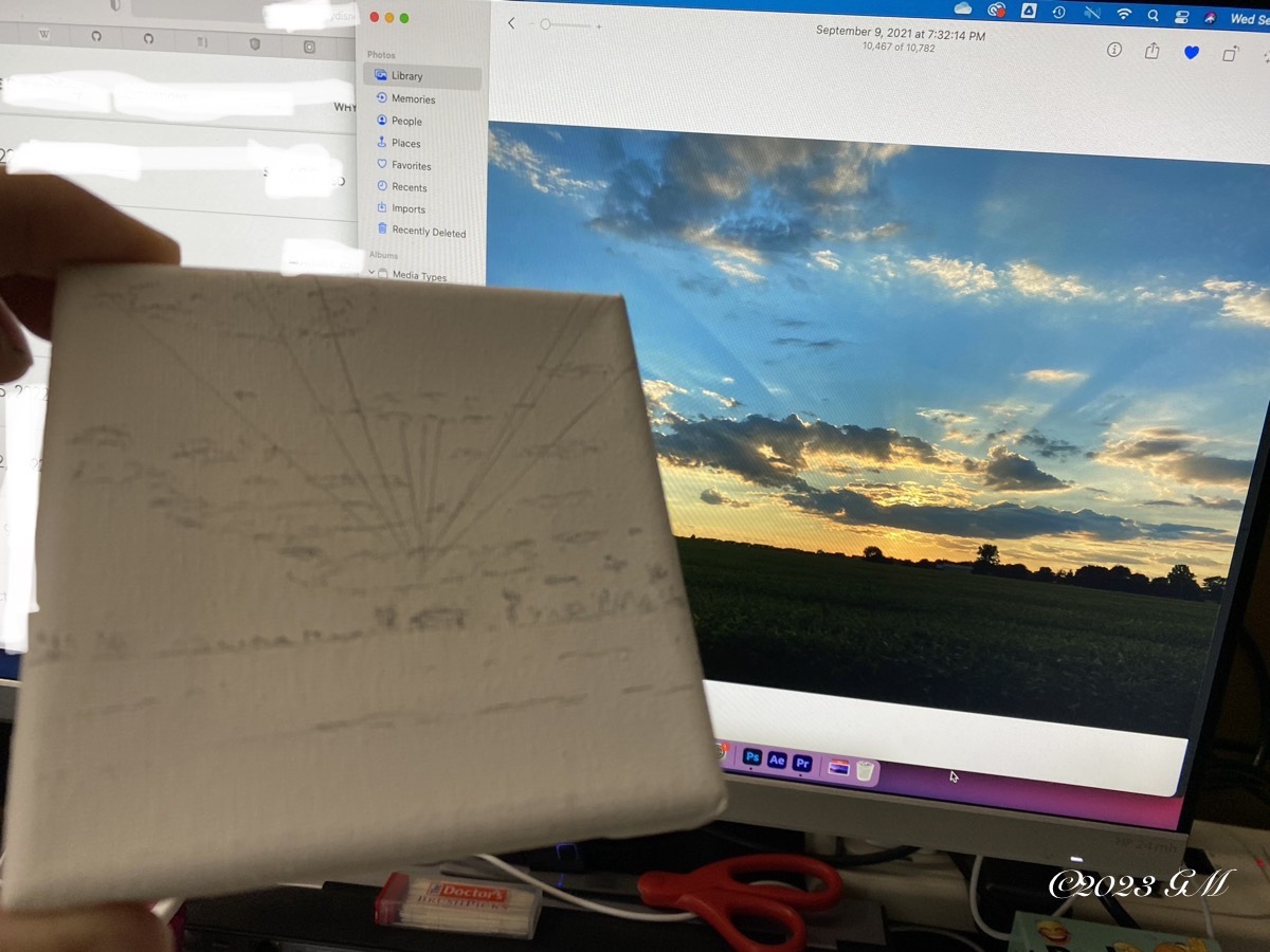 Sketch of this painting in front of a reference photo of the sunset